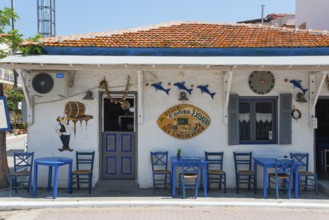 Mediterranean restaurant with murals, blue chairs and traditional outdoor decoration, Sarti,