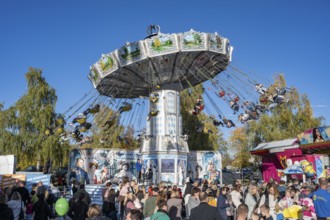 Crowd of people on fairground, amusement park, amusement ride, chain carousel, showmen, on the