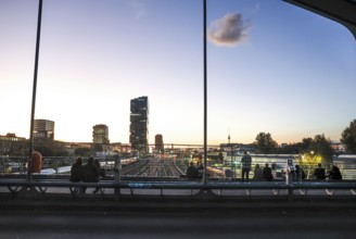 Chilling out at sunset on the Modersohn Bridge, view of railway tracks, trains and the 140 metre