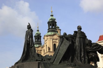 Jan Hus Monument on the Old Town Square and the towers of St Nicholas Church, Prague, Czech