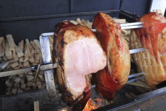 Pieces of pork are grilled on a spit over a wood fire, a speciality in Prague, Czech Republic,