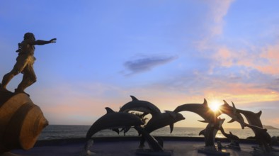 Mexico, Dolphin silhouettes at Mazatlan sea promenade, El Malecon near tourist beaches and scenic