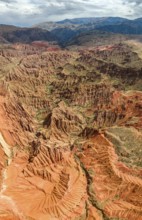 Eroded mountain landscape, canyon with red and orange rock formations, aerial view, Konorchek