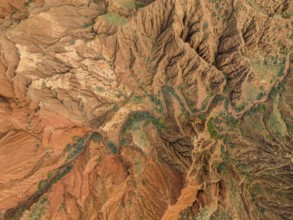 Eroded mountain landscape, top-down, canyon with red and orange rock formations, aerial view,