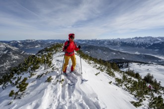 Ski tourer at the summit of Simetsberg, mountain panorama, Estergebirge, Bavarian Prealps, Bavaria