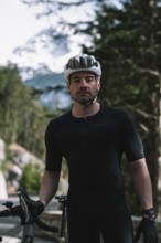 Road bike rider in spring in the Allgäu against the picturesque backdrop of the Alps, Bavaria,