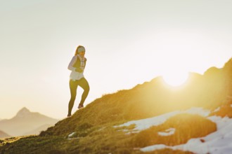 Trail running in autumn on the Jochberg on Lake Walchensee against the wonderful backdrop of the