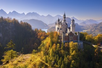 Neuschwanstein Castle in autumnal surroundings, surrounded by mountains, Schwangau, Ostallgäu,