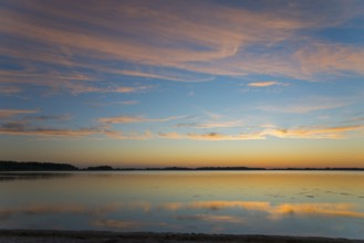 Peaceful sunrise over a smooth lake with pastel-coloured sky and reflections, sunset, Zatoka