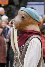 Person masked as a walrus at the carnival parade of the Wey guild on Rose Monday, Güdismäntig,