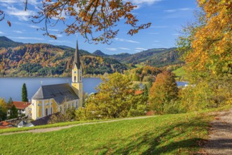 Panorama of the village and lake with the parish church of St. Sixtus in autumn, Schliersee,