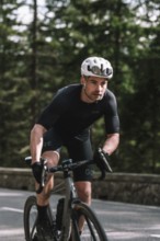 Road bike rider in spring in the Allgäu against the picturesque backdrop of the Alps, Bavaria,