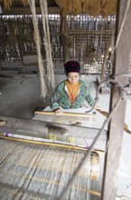 Vietnamese woman from the Hmong minority weaves linen fabric, Lung Tam linen weaving mill, Ha Giang