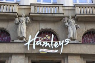 Façade with the lettering of Hamleys Toy Store and two historical female figures, Prague, Czech