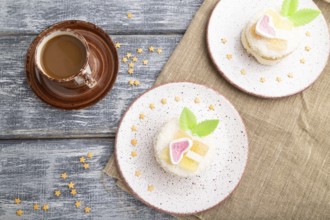 Decorated cake with milk and coconut cream with cup of coffee on a gray wooden background and linen