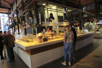 Customers inside Mercado de San Miguel market, Madrid city centre, Spain, Europe