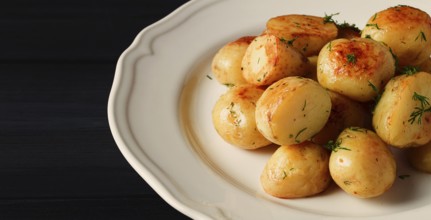 Fresh Cooked, new potatoes, with dill, on a wooden table, selective focus. close-up, toning, no