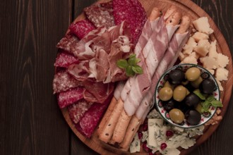 Appetizer, assortment, set, sausage, and cheese, on a wooden board, top view, no people