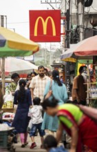 People walks by a McDonald's sign on October 26, 2024 in Guwahati, India. McDonald's recent food