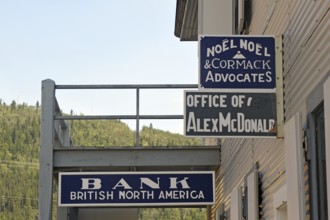 Historic signs advertising bank and lawyer, gold rush, gold mining town, Dawson City, Yukon