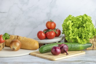 Fresh vegetables and a baguette arranged on a kitchen counter, copy room