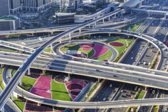 Intersection of Sheikh Zayed Road traffic on the road near the Burj Khalifa with Metro in Dubai,