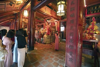 Vietnamese woman pray at the altar of Confucius in the Temple of Literature in the Old Quarter of