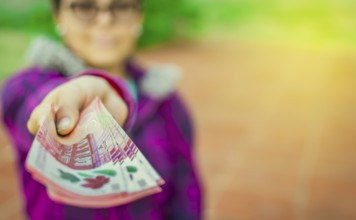 Young woman showing nicaraguan banknotes. Nicaraguan 500 cordobas banknotes