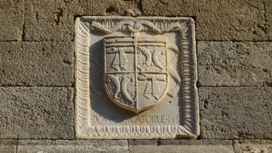 Small stone relief with a coat of arms and decorations, carved into a wall, Knights' Street, Rhodes