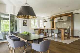 Chrome and walnut wood table with charcoal linen armchairs, large black and gold industrial style