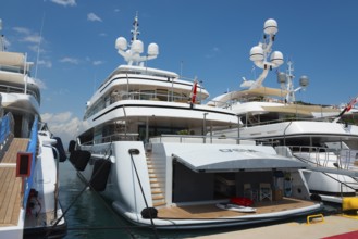 White modern yacht in the harbour with a view of the blue sky, Mediterranean yacht show, harbour,