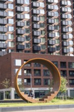 Walk-in steel sculpture on Maashaven Noordzijde Street, new high-rise residential buildings in the