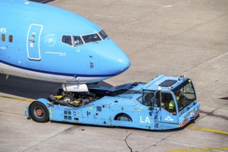 Boeing 737-800 from KLM, being driven from the terminal onto the apron, pushback, with an aircraft