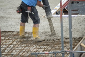 Construction site, concreting, the floor slab of a building is concreted, the concrete is pumped