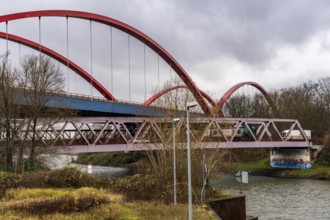 Dilapidated A42 motorway bridge (red arches) over the Rhine-Herne Canal, with massive structural