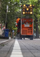 Application of road markings for a cycle lane, Rüttenscheider Straße in Essen, in the shopping and