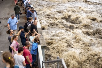 Weir of the Lake Baldeney in Essen, the masses of water roar through the open weirs, spectators,