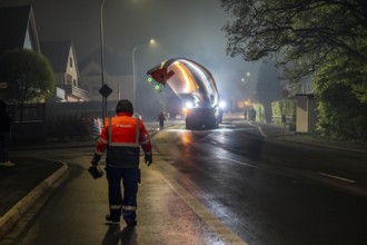 Transport of a 68 metre long, 22 tonne blade of a wind turbine, here in Breckerfeld, with a