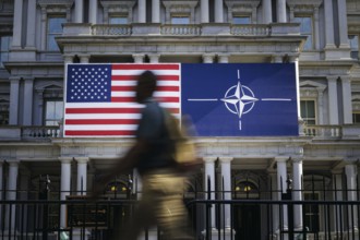 The flags of the USA and NATO hang on a building in Washington on the sidelines of the NATO summit.