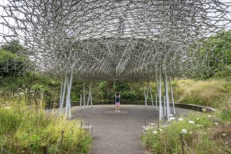 Visitor stands under The Hive, artwork by Wolfgang Buttress, Royal Botanic Gardens (Kew Gardens),