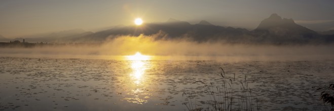 Sunrise at Lake Hopfensee near Füssen, behind Hopfen am See, the Tegelberg massif and the Säuling,