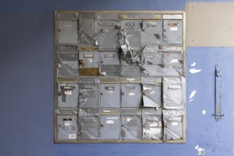 Doorbell sign, broken letterbox system on a dilapidated block of flats in Stuttgart,