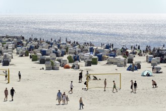 View of the beach with beach chairs and areas for sports, blue sky, North Sea, Norddeich, Lower