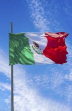 Los Cabos, Mexico, Mexican tricolor national striped flag proudly waving at mast in the air with