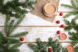 Christmas or New Year composition. Decorations, red balls, fir and spruce branches, cup of coffee,