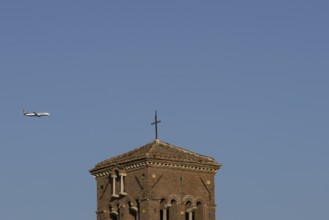 Boeing 737 jet passenger aircraft of Ryanair flying in a blue sky over an ancient city building,