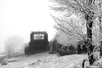 Aubrac plateau. Typical bell tower of Prinsuejols in winter. Lozere department. Occitanie. France