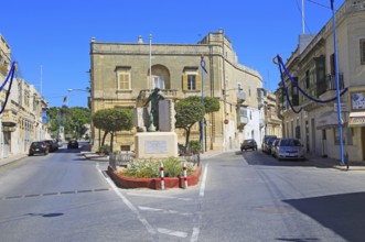 Historic streets in Tarxien area, near Valletta, Malta small square with war memorial sculpture