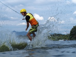 Man jumping with wakeboard, water sports, water skiing and wakepark