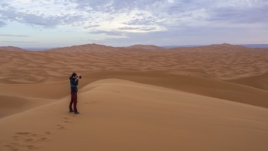 Woman photographed in desert, dunes, Erg Chebbi, Sahara, Merzouga, Morocco, Africa